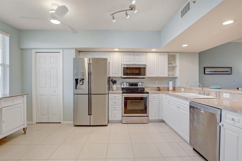 960 Starkey Road, Unit 2405 Largo, FL 33771 - Photo 6 of 31 a kitchen with a sink stainless steel appliances and cabinets