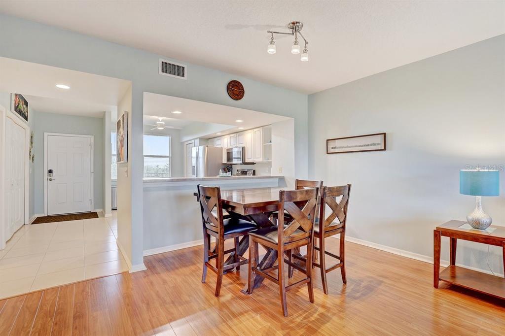 960 Starkey Road, Unit 2405 Largo, FL 33771 - Photo 10 of 31 a view of a dining room with furniture and wooden floor