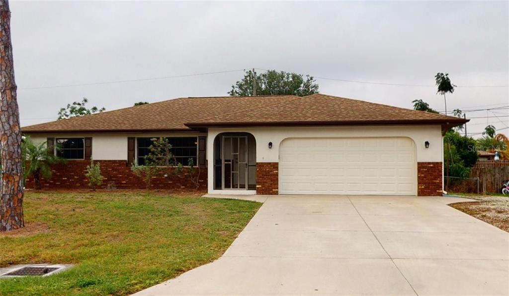 1188 Panda Road Venice, FL 34293 - Photo 1 of 1 a front view of a house with a yard and potted plants