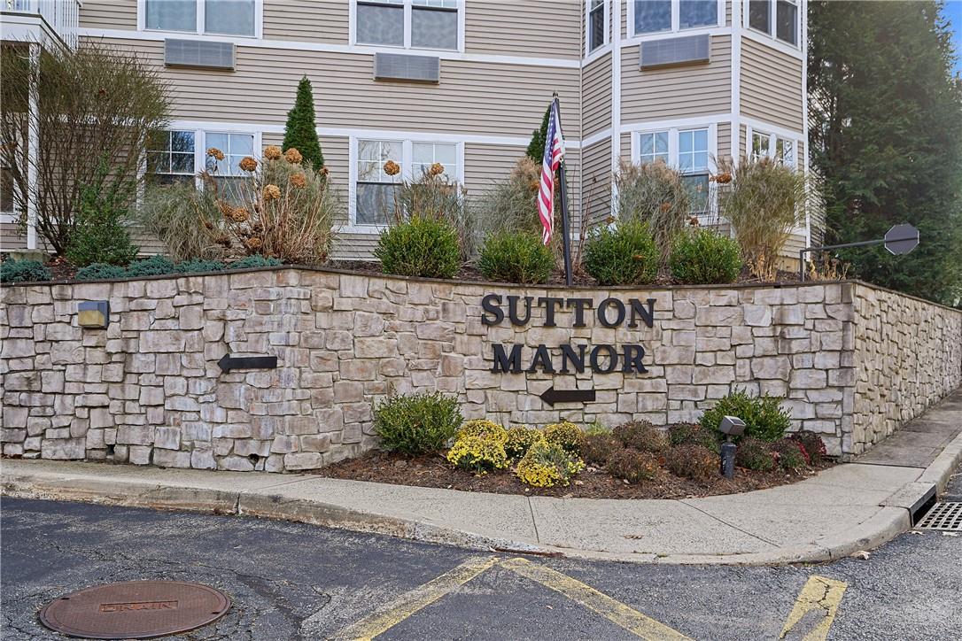 a view of a brick house with a yard and table and chairs