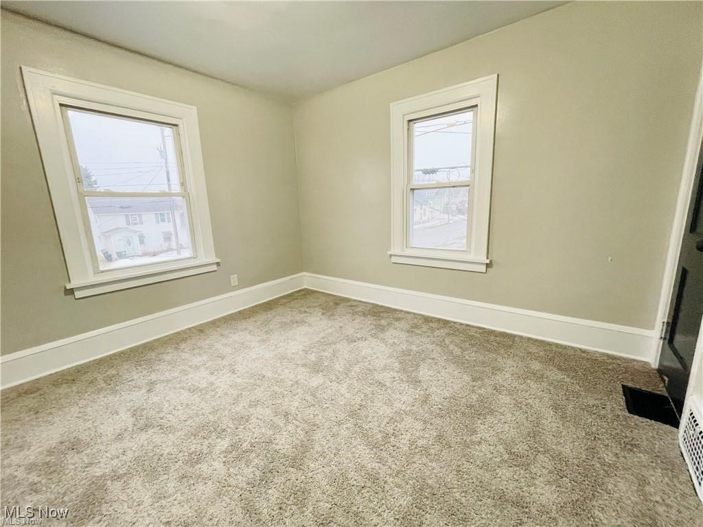 2511 4th Street Northwest Canton, OH 44708 - Photo 5 of 20 Spare room with healthy amount of natural light, carpet flooring, and baseboards