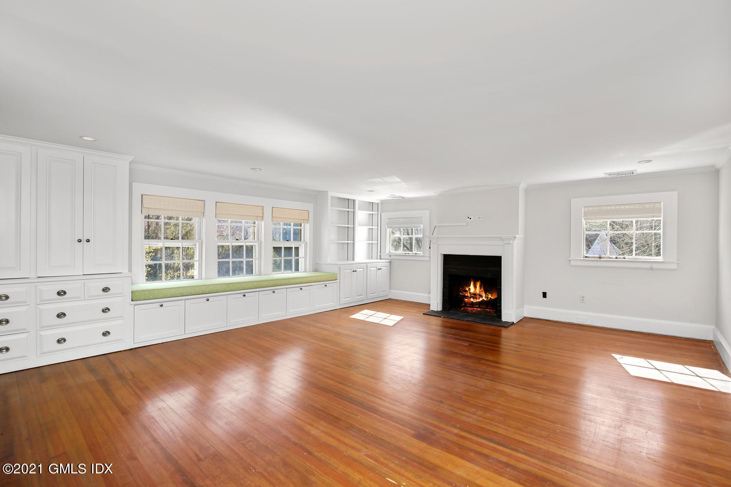 187 Stanwich Road Greenwich, CT 06830 - Photo 15 of 31 a view of an empty room with wooden floor fireplace and a window