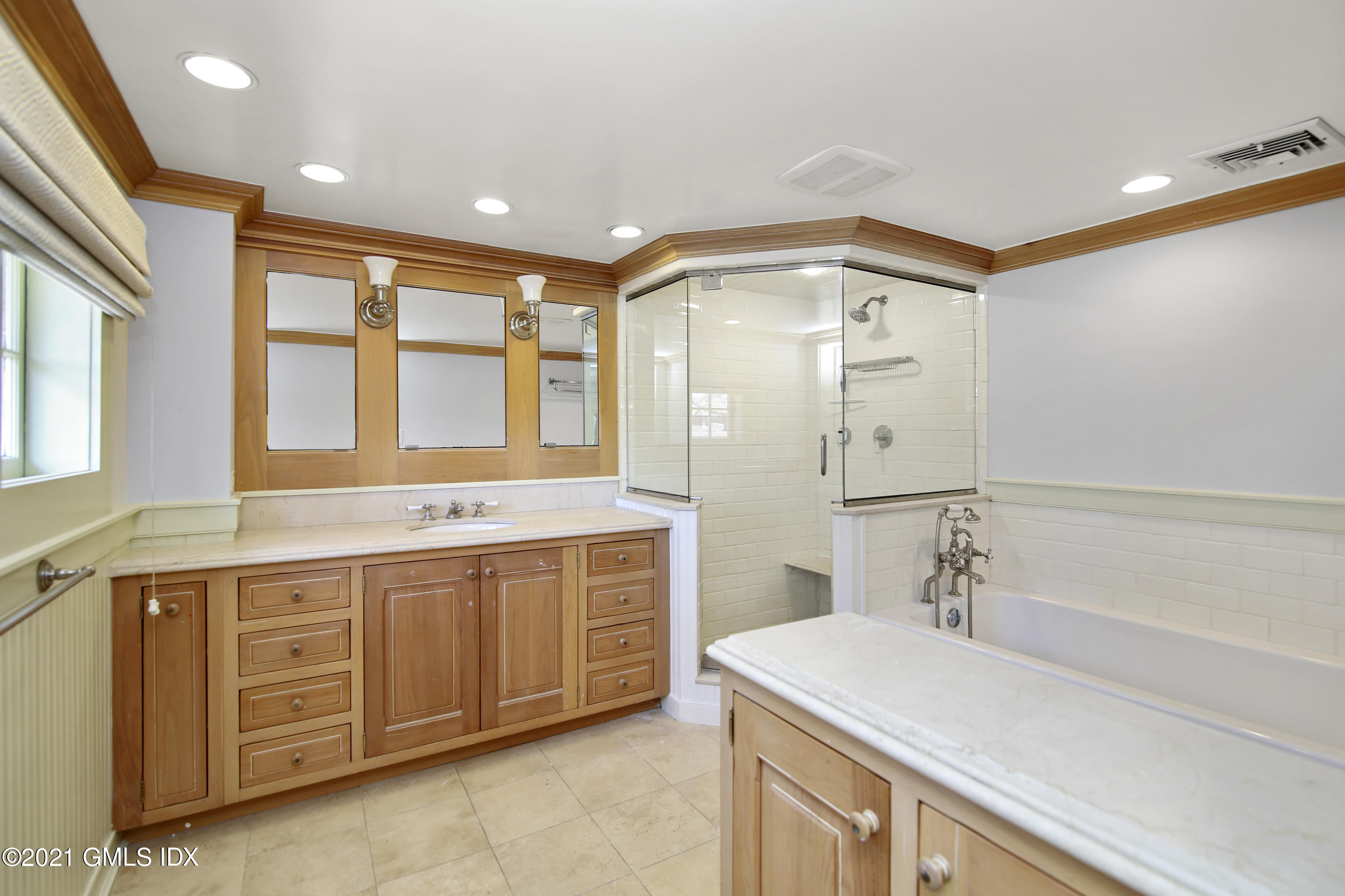187 Stanwich Road Greenwich, CT 06830 - Photo 16 of 31 a bathroom with a sink double vanity and a bathtub