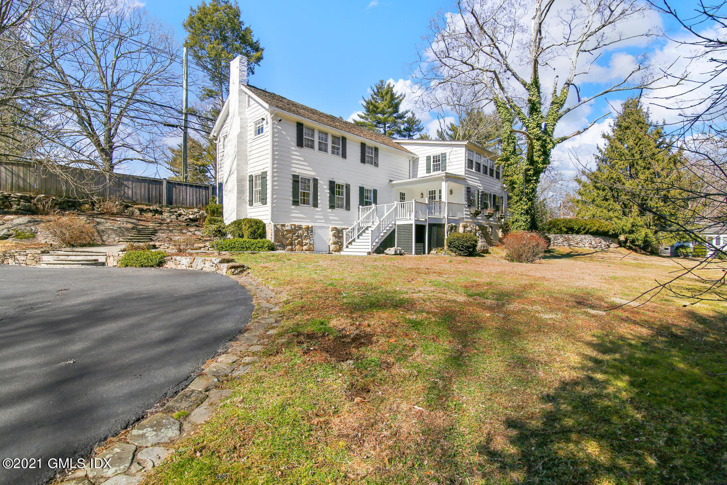 187 Stanwich Road Greenwich, CT 06830 - Photo 2 of 31 a view of a white house with a yard covered with snow