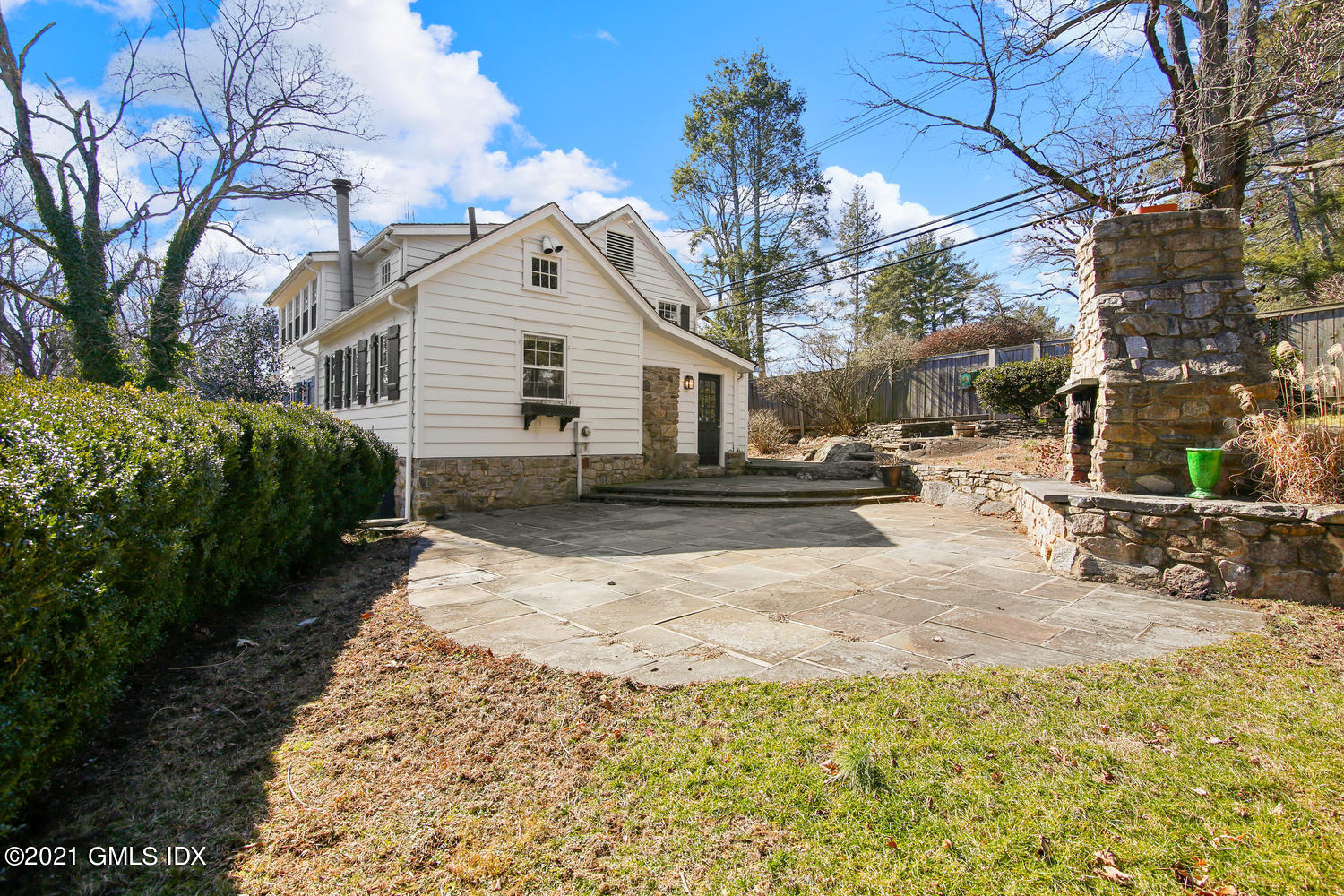187 Stanwich Road Greenwich, CT 06830 - Photo 25 of 31 a view of a house with a yard covered in snow