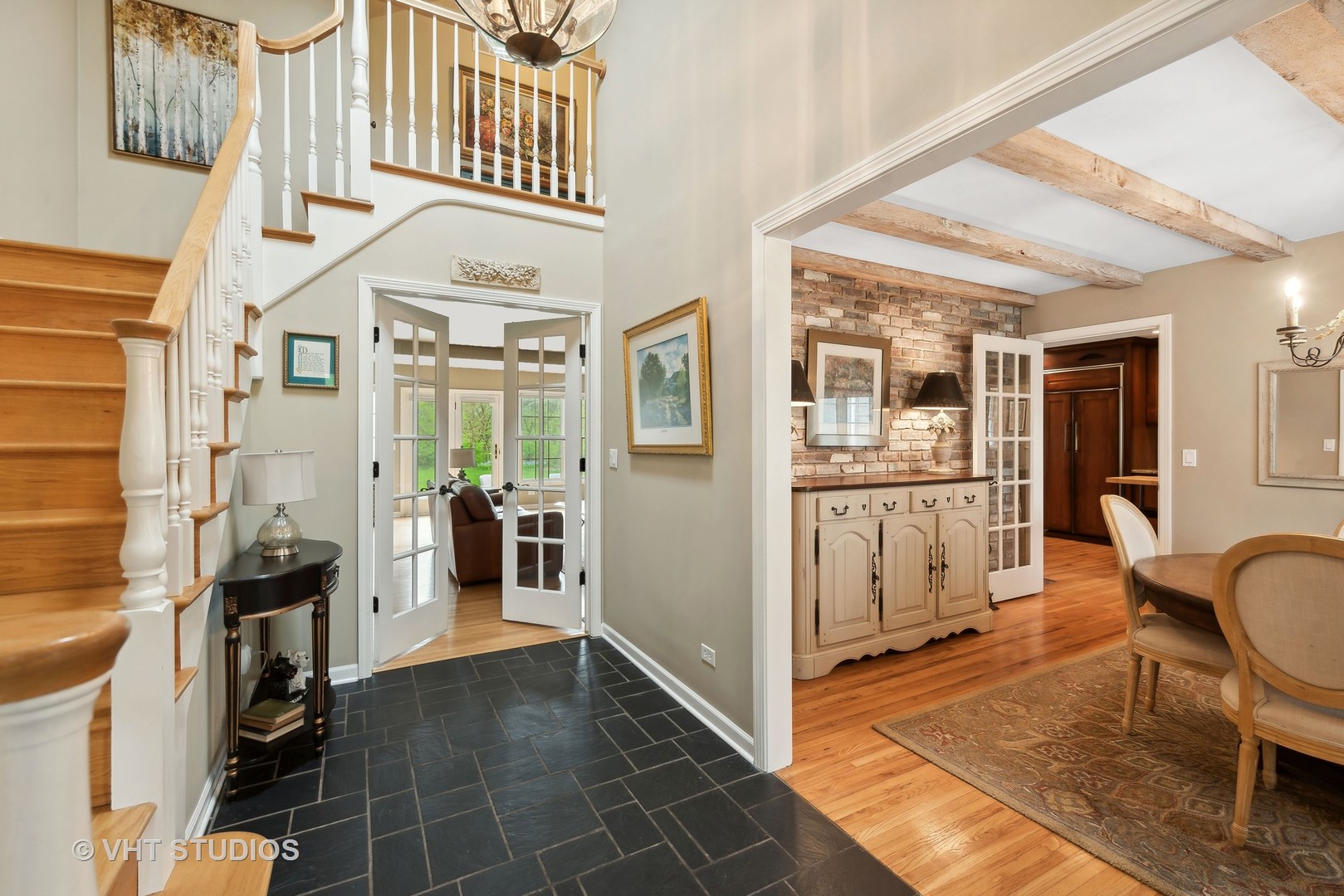 229 Valley Road Trout Valley, IL 60013 - Photo 3 of 38 a view of a hallway with dining area and chandelier