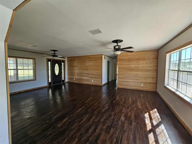 a view of a livingroom with a ceiling fan and a window