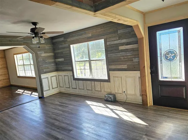 a kitchen with wooden floors and stainless steel appliances