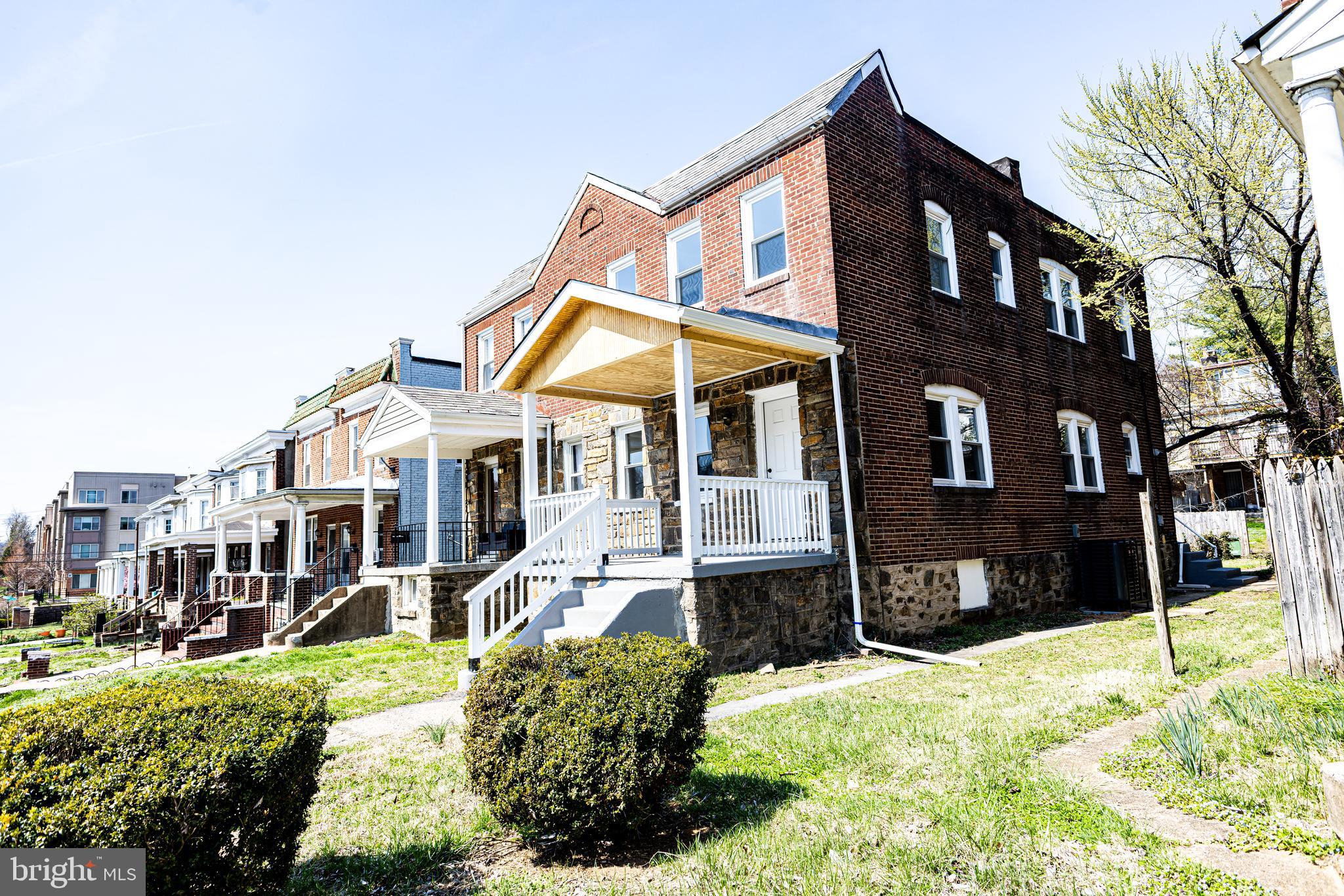 4220 Frederick Avenue Baltimore, MD 21229 - Photo 1 of 24 a front view of a house with a yard