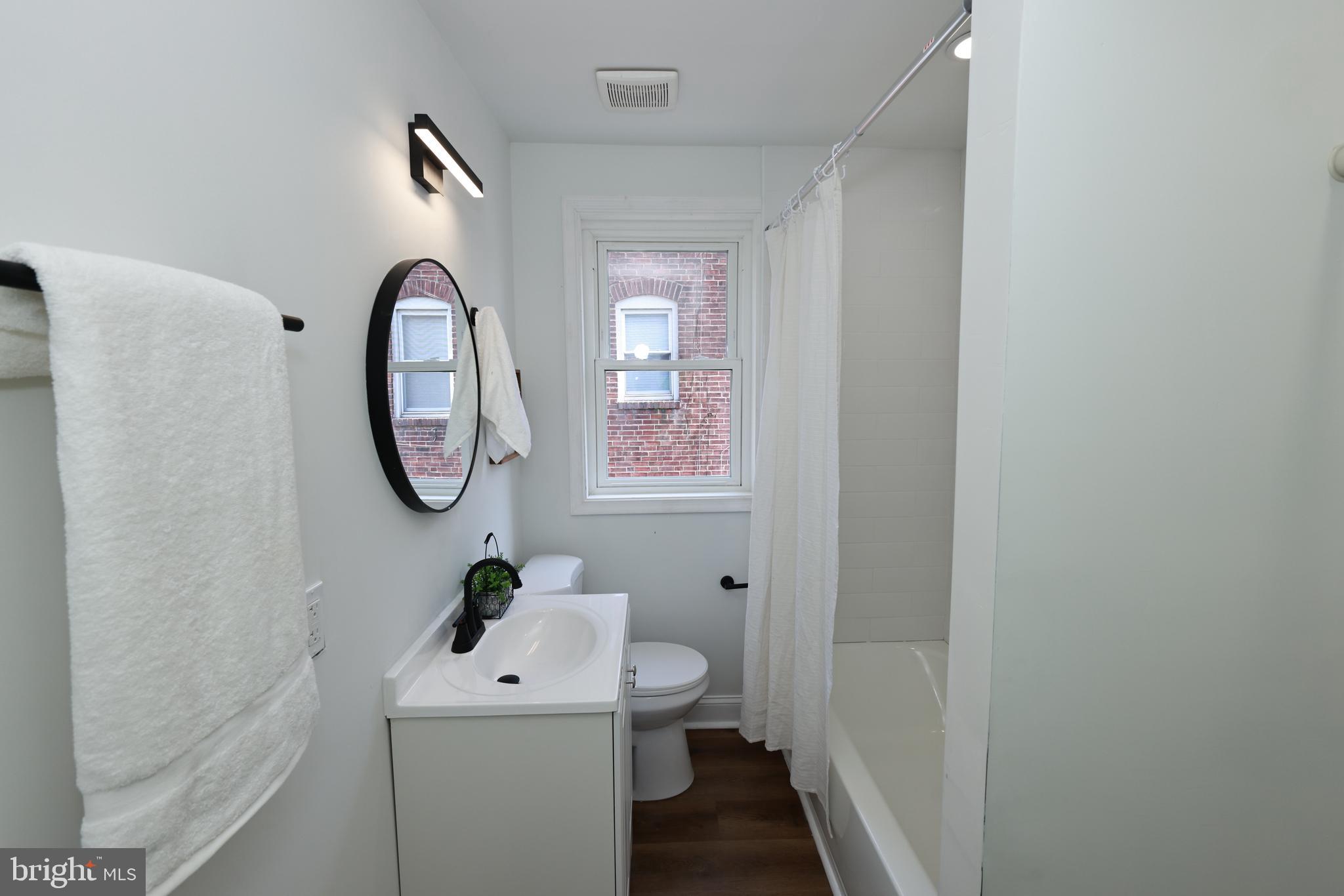 4220 Frederick Avenue Baltimore, MD 21229 - Photo 11 of 24 a bathroom with a sink mirror and toilet