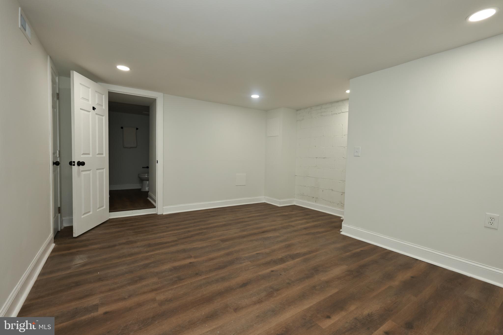 4220 Frederick Avenue Baltimore, MD 21229 - Photo 17 of 24 a view of an empty room with wooden floor
