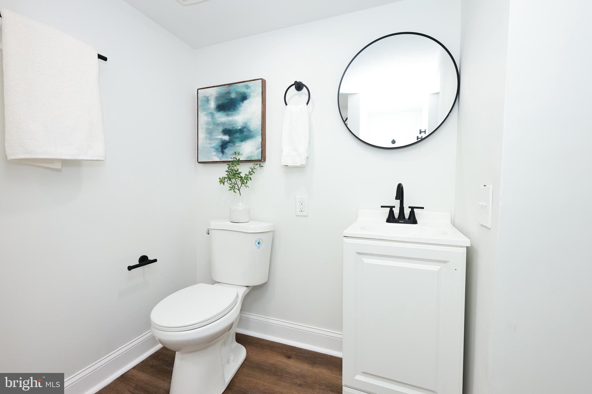 4220 Frederick Avenue Baltimore, MD 21229 - Photo 18 of 24 a bathroom with a toilet a sink and a mirror