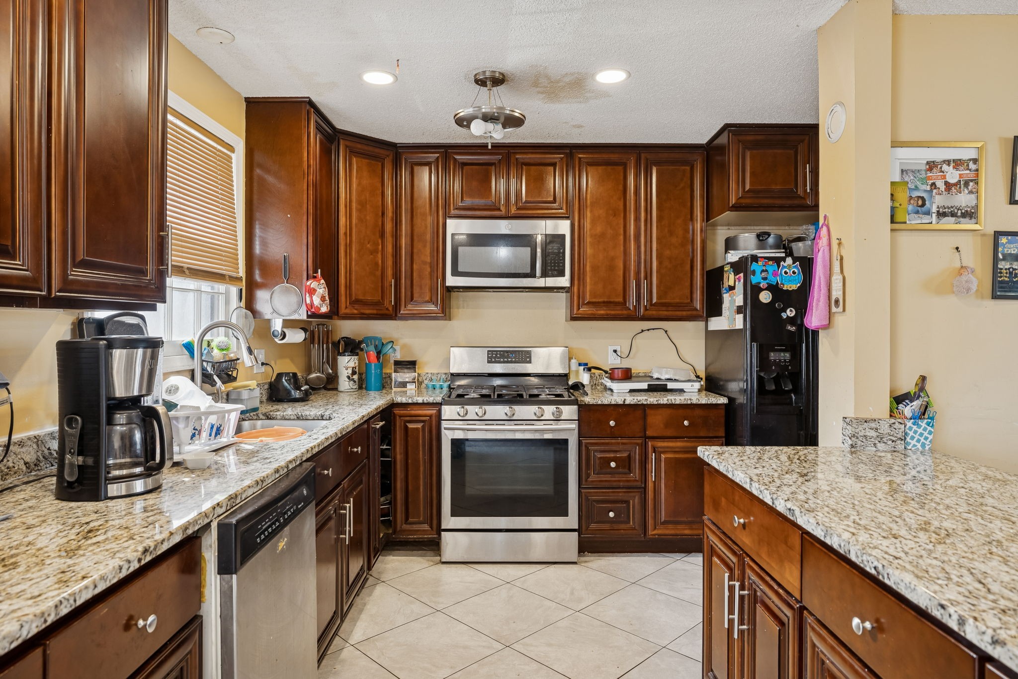 512 Rural Hill Road Nashville, TN 37217 - Photo 6 of 16 a kitchen with stainless steel appliances granite countertop a stove top oven a sink and dishwasher