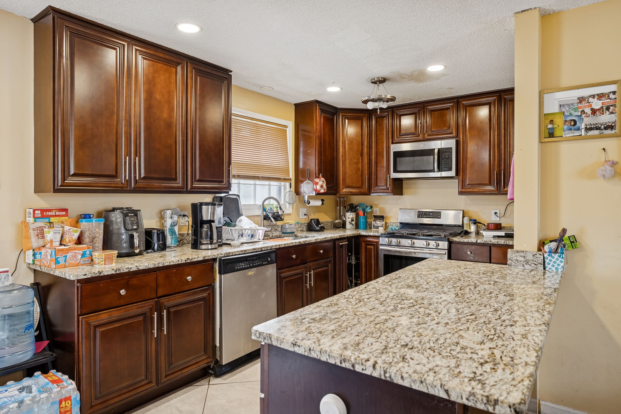 512 Rural Hill Road Nashville, TN 37217 - Photo 7 of 16 a kitchen with stainless steel appliances granite countertop a refrigerator sink and cabinets