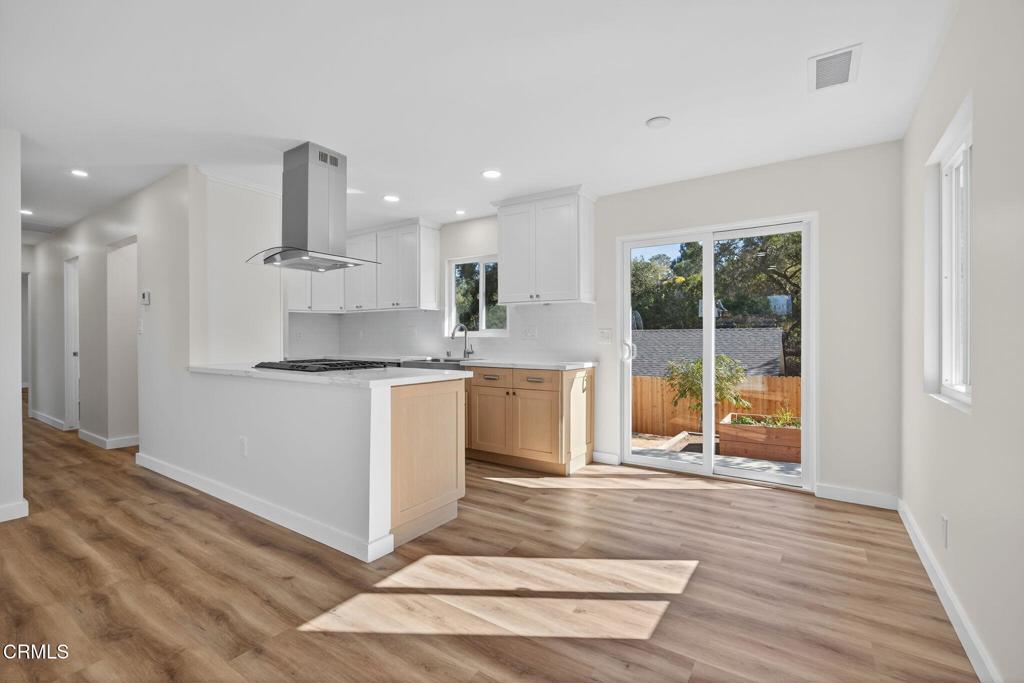310 Prospect Street Oak View, CA 93022 - Photo 11 of 38 a kitchen with kitchen island granite countertop a sink cabinets and a counter top space