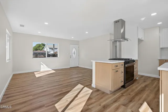 a kitchen with a sink cabinets and wooden floor