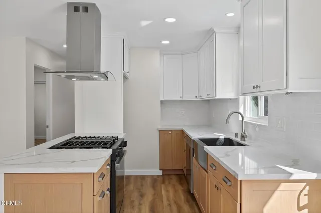 a kitchen that has a sink and a stove