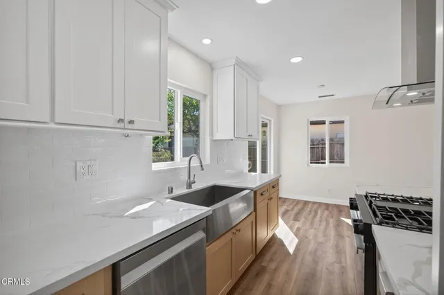 a kitchen with a sink stove and cabinets