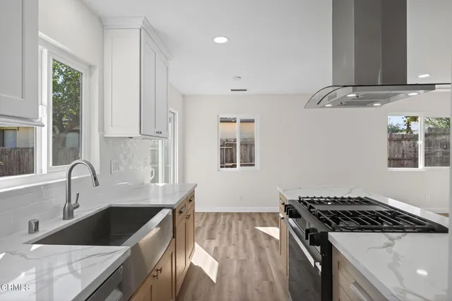 a kitchen with granite countertop a stove and a sink