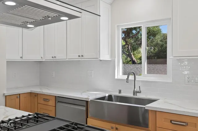 a kitchen that has a sink and a stove