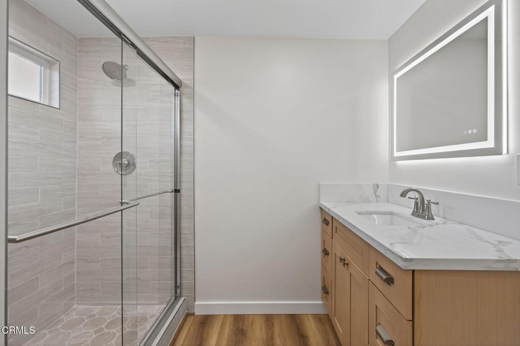 310 Prospect Street Oak View, CA 93022 - Photo 19 of 38 a bathroom with a granite countertop sink a mirror and shower