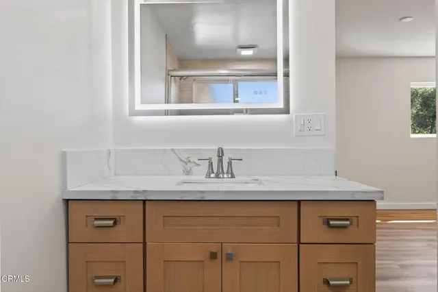 a bathroom with a sink and a mirror