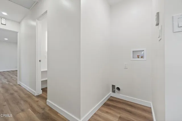 a view of room with wooden floor
