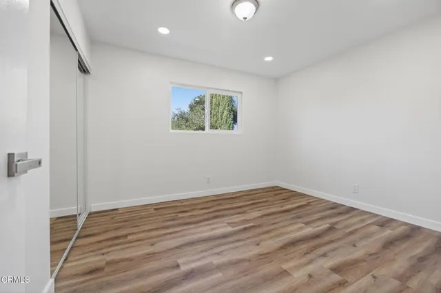 a view of room with wooden floor and window