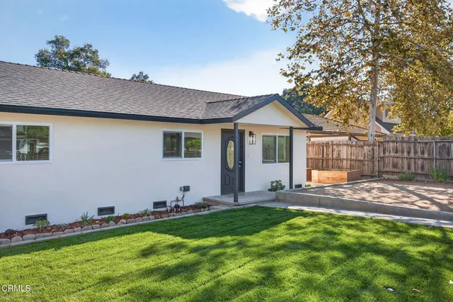 a front view of house with yard and outdoor seating