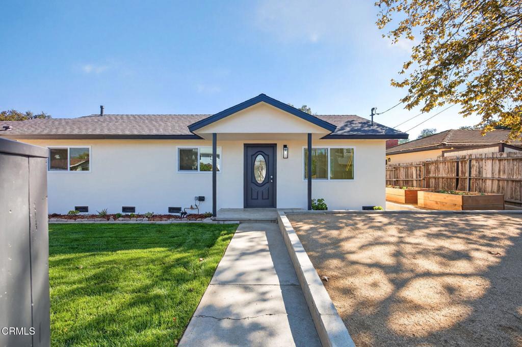 310 Prospect Street Oak View, CA 93022 - Photo 7 of 38 a front view of a house with a yard and garage