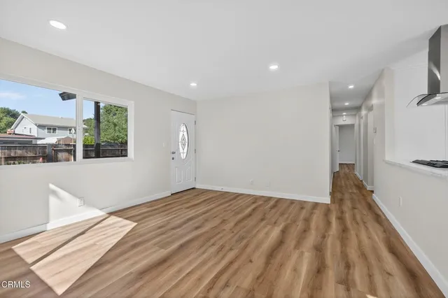 a view of an empty room and a window