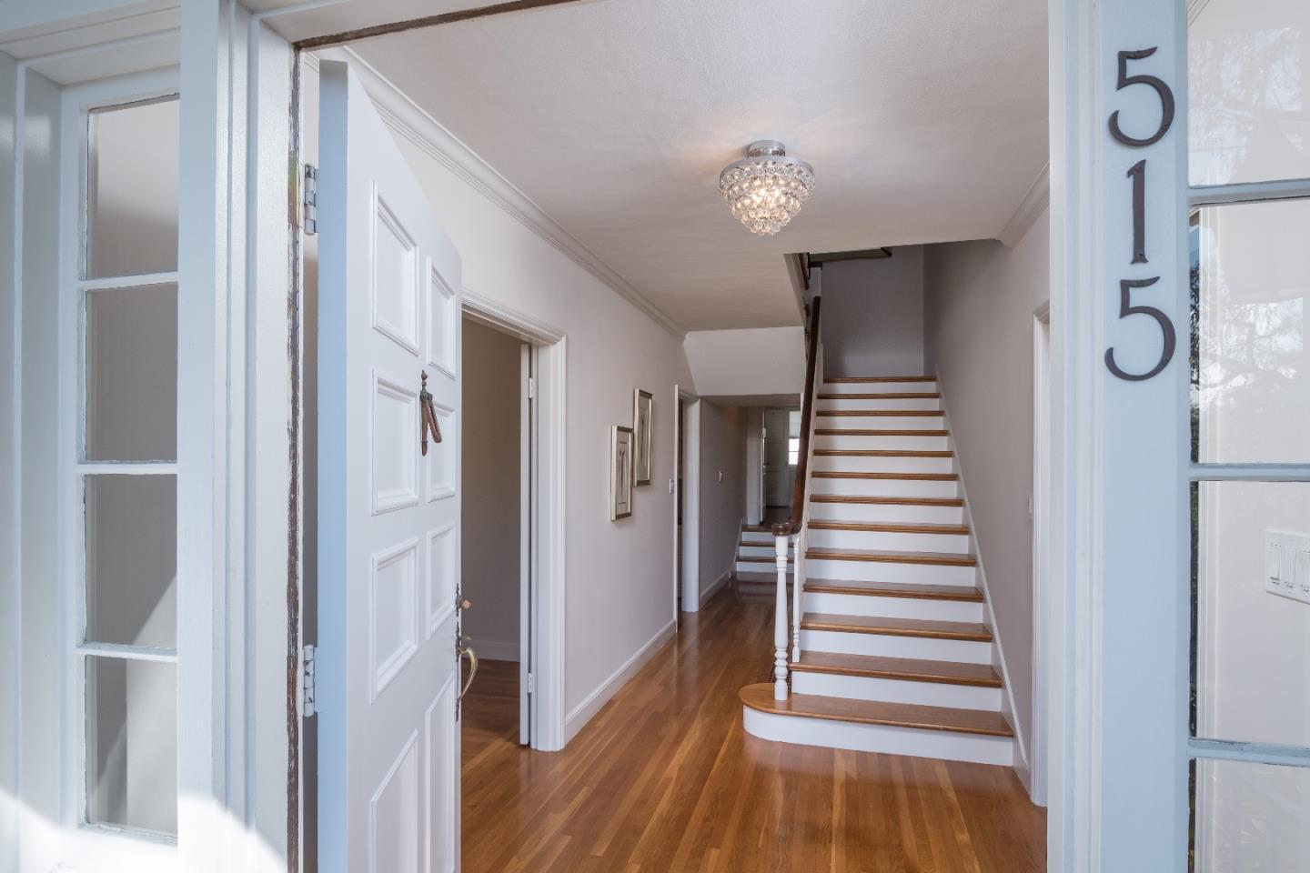 515 Warren Road San Mateo, CA 94402 - Photo 3 of 27 a view of a hallway with wooden floor and staircase