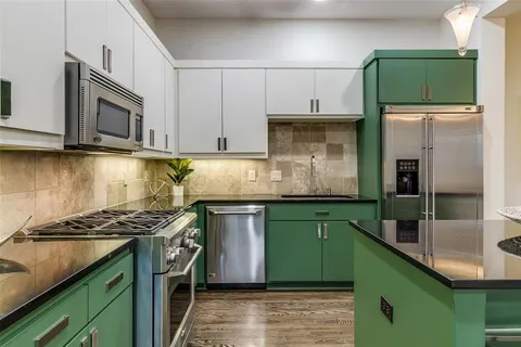 a kitchen with cabinets and a refrigerator