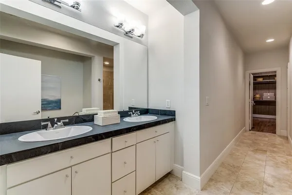 a bathroom with double sink and a mirror