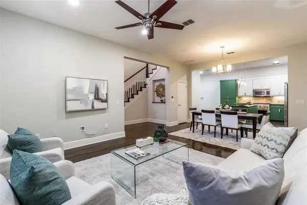 a living room with furniture and kitchen view