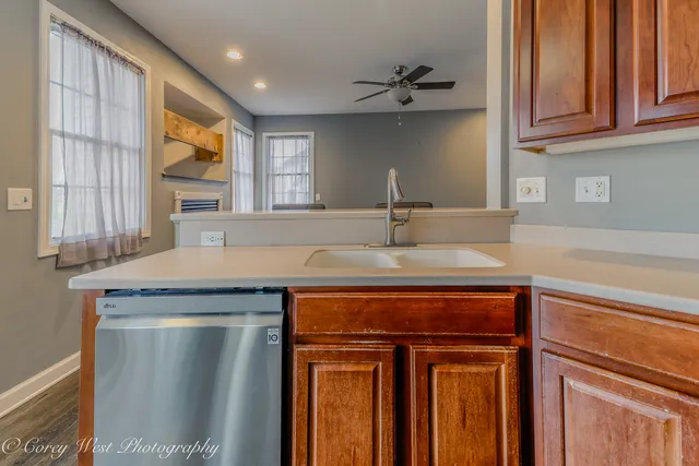 a kitchen with stainless steel appliances granite countertop a refrigerator stove and sink