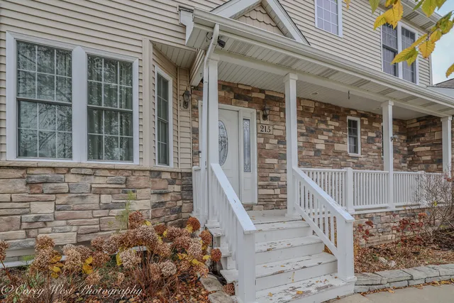 front view of a brick house with large windows