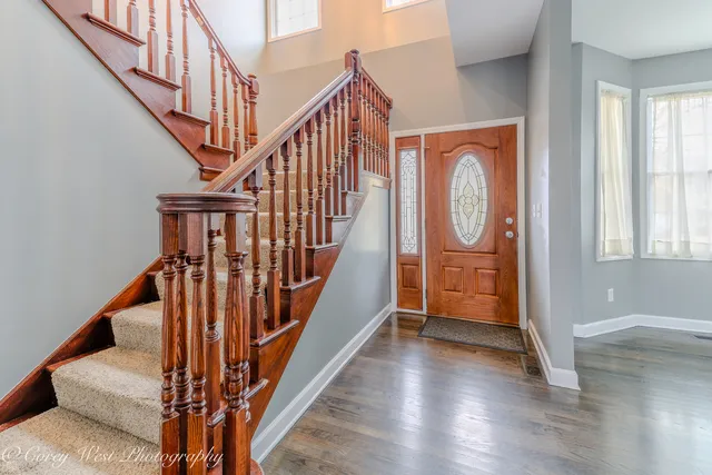 a view of an entryway with wooden floor
