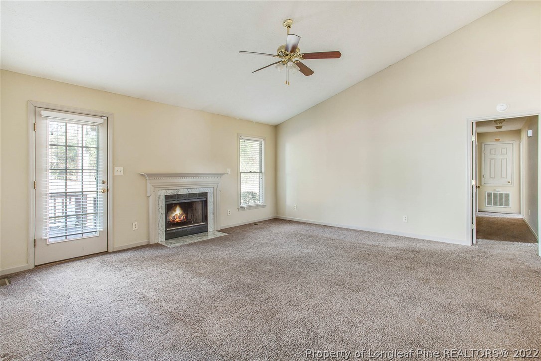 2608 Laurel Lakes Road Fayetteville, NC 28301 - Photo 14 of 32 a view of an empty room with a fireplace and a window