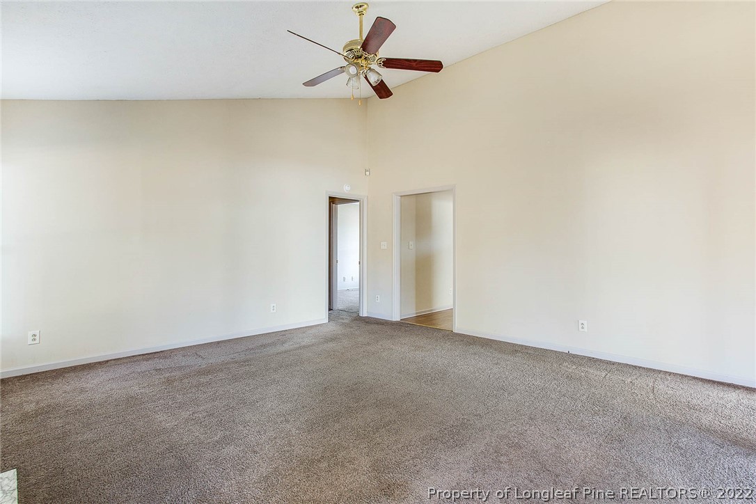 2608 Laurel Lakes Road Fayetteville, NC 28301 - Photo 15 of 32 an empty room with a ceiling fan and carpet