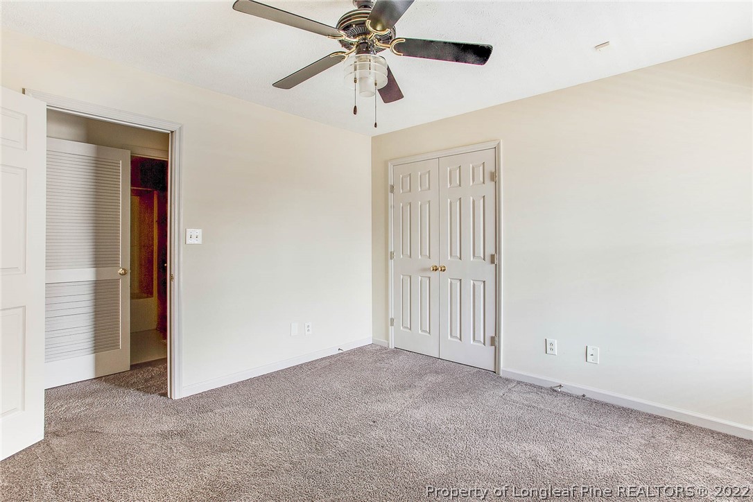 2608 Laurel Lakes Road Fayetteville, NC 28301 - Photo 20 of 32 an empty room with closet and a chandelier fan