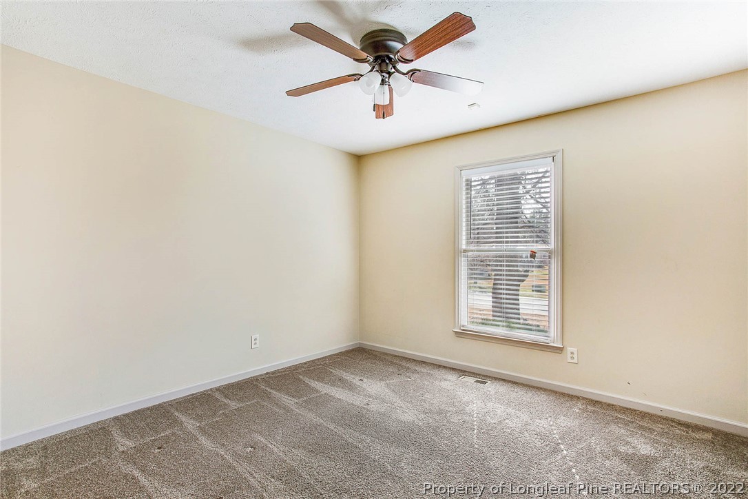 2608 Laurel Lakes Road Fayetteville, NC 28301 - Photo 22 of 32 an empty room with a window and a ceiling fan