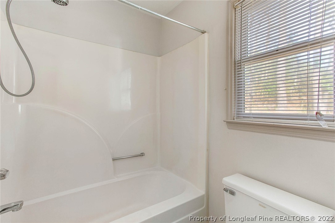 2608 Laurel Lakes Road Fayetteville, NC 28301 - Photo 27 of 32 a bathroom with a toilet and a bathtub
