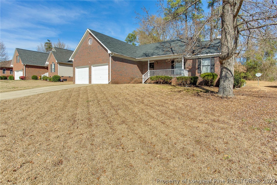 2608 Laurel Lakes Road Fayetteville, NC 28301 - Photo 3 of 32 a front view of a house with a yard and garage