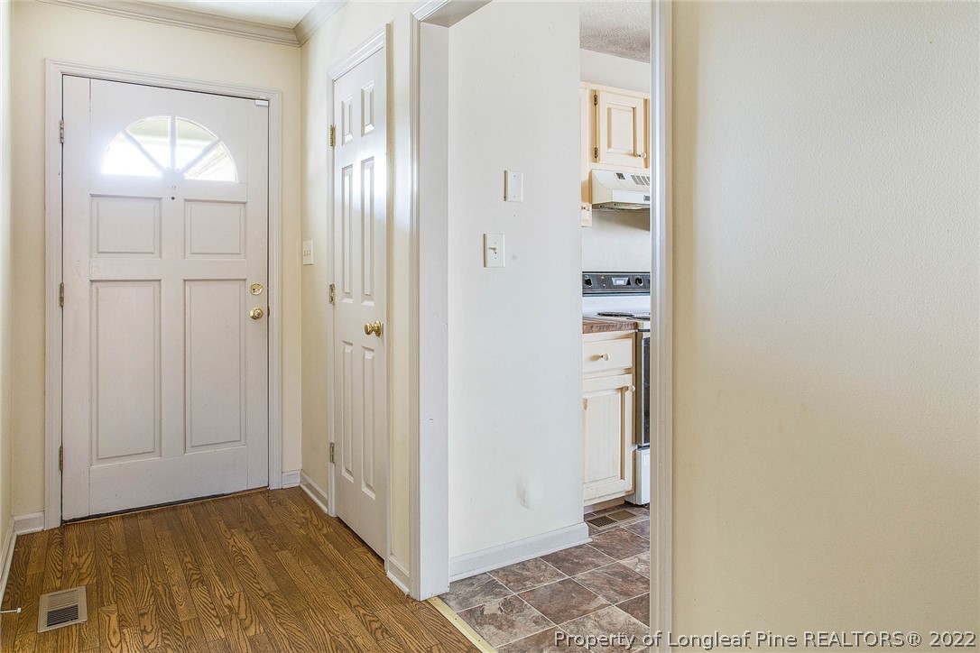 2608 Laurel Lakes Road Fayetteville, NC 28301 - Photo 6 of 32 a view of a hallway with wooden floor and closet