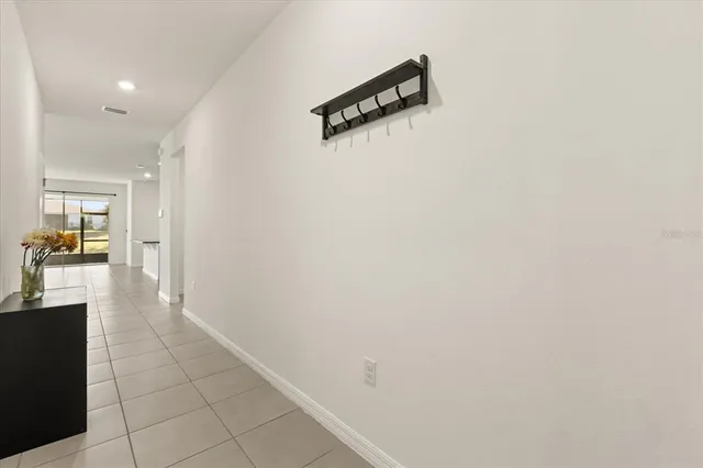 a hallway with table and chairs