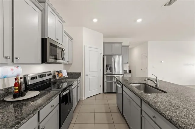 a kitchen with a sink and stainless steel appliances