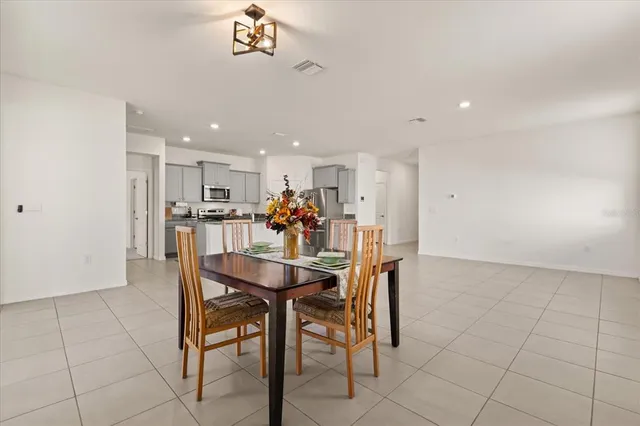 a dining room with furniture and window