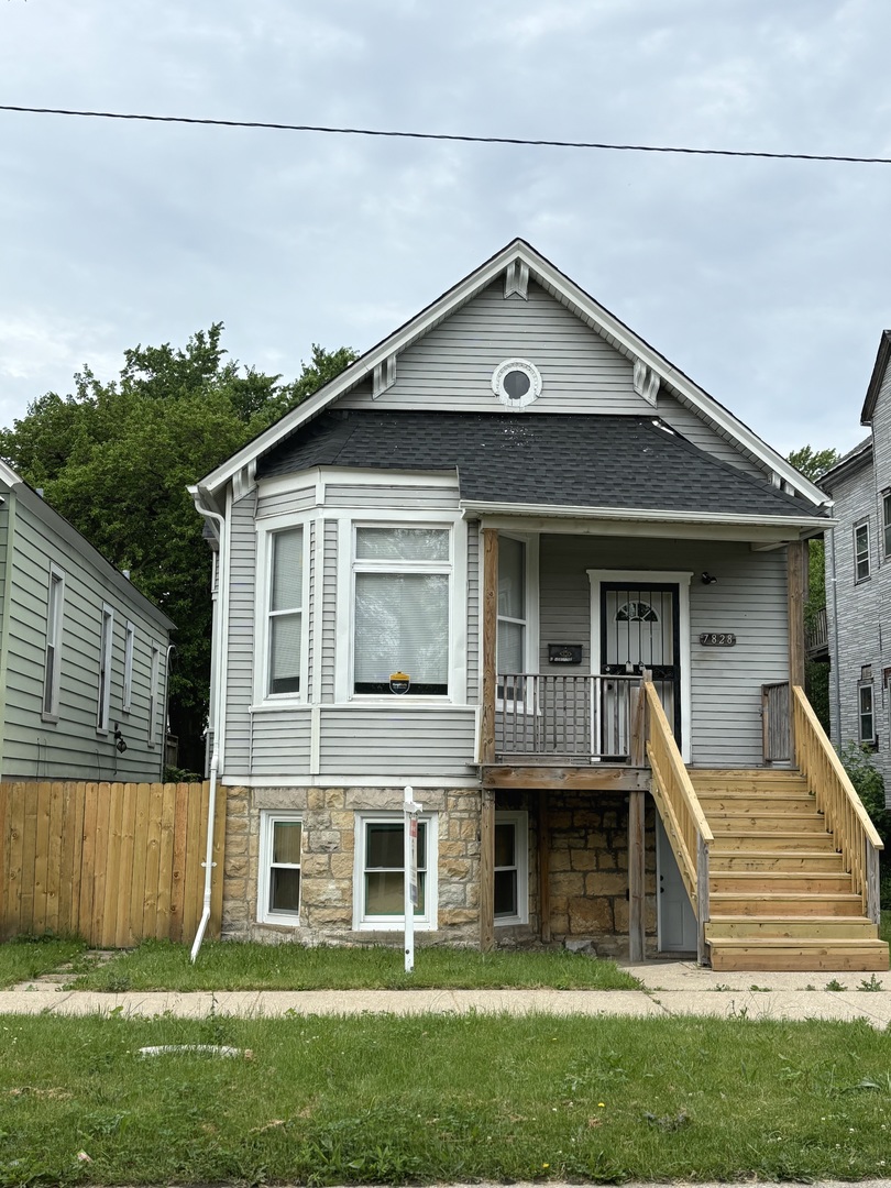 7828 South Escanaba Avenue Chicago, IL 60649 - Photo 1 of 41 a view of a house with a yard