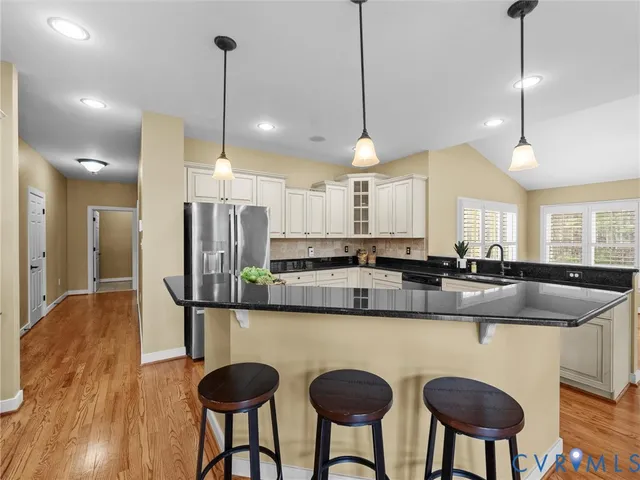 a view of a kitchen with furniture and wooden floor